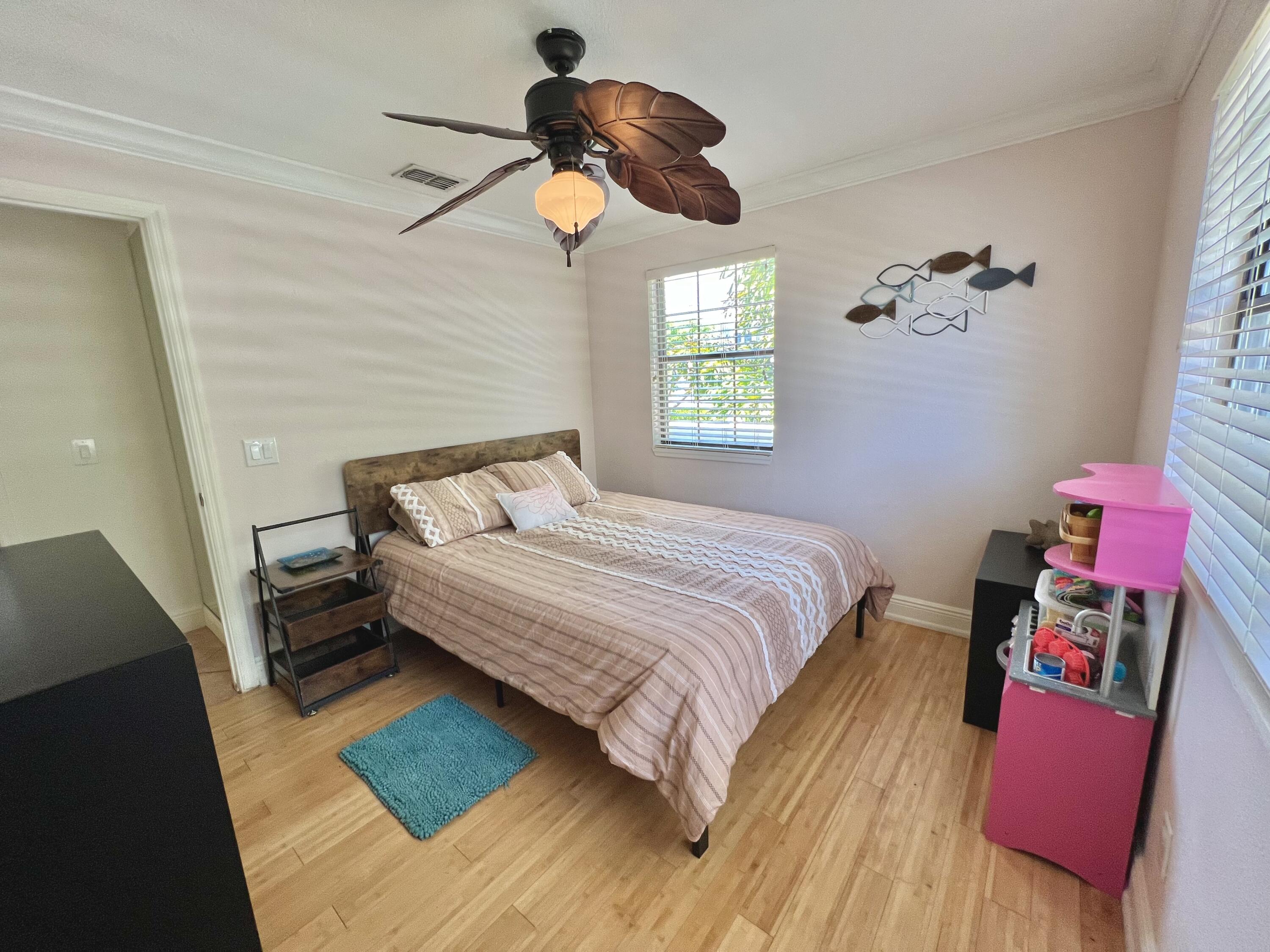 24 Bounty Lane Key Largo, FL 33037 - Photo 13 of 36 a bedroom with a bed and a chandelier