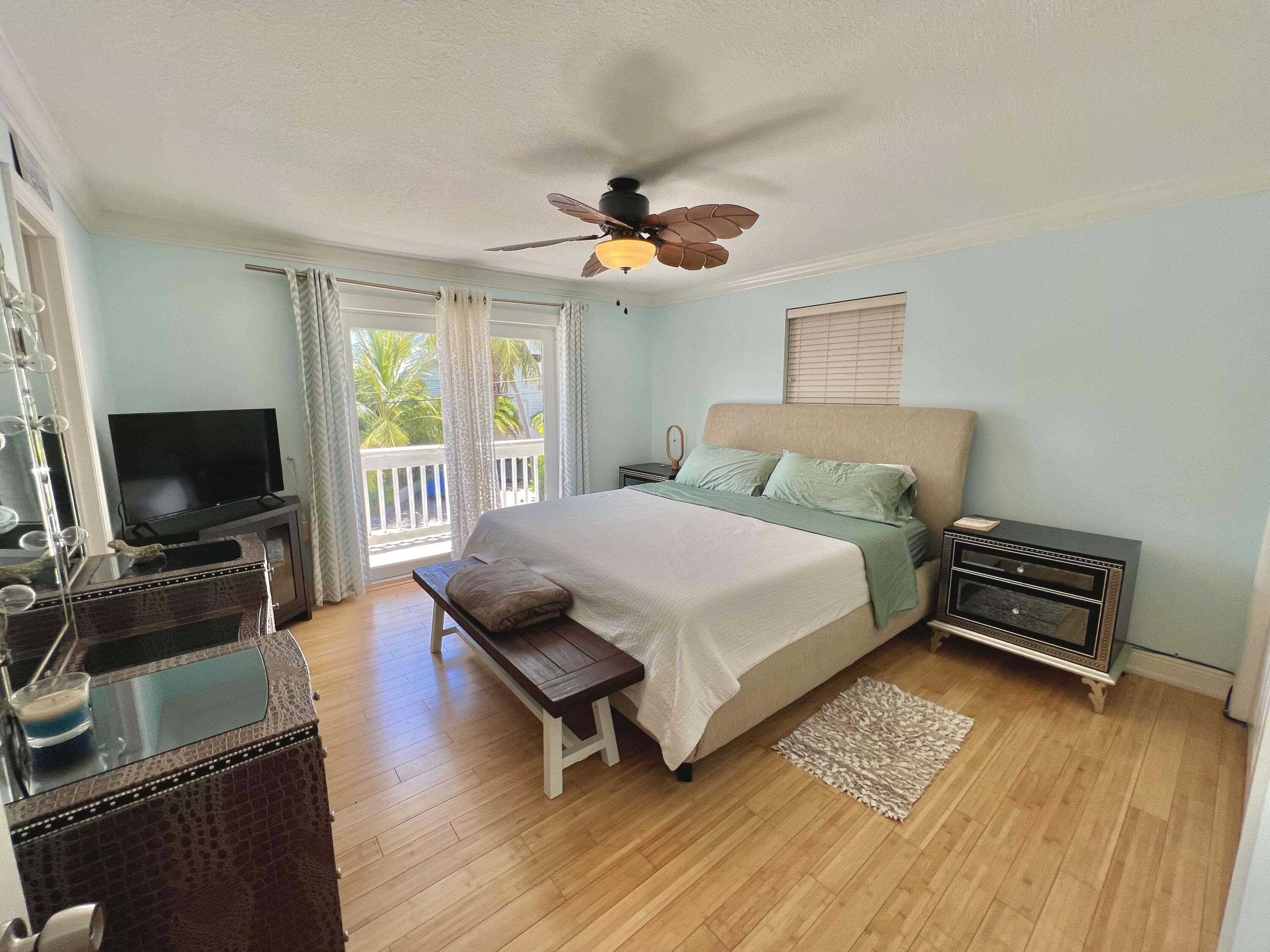 24 Bounty Lane Key Largo, FL 33037 - Photo 14 of 36 a bedroom with a bed and a flat screen tv