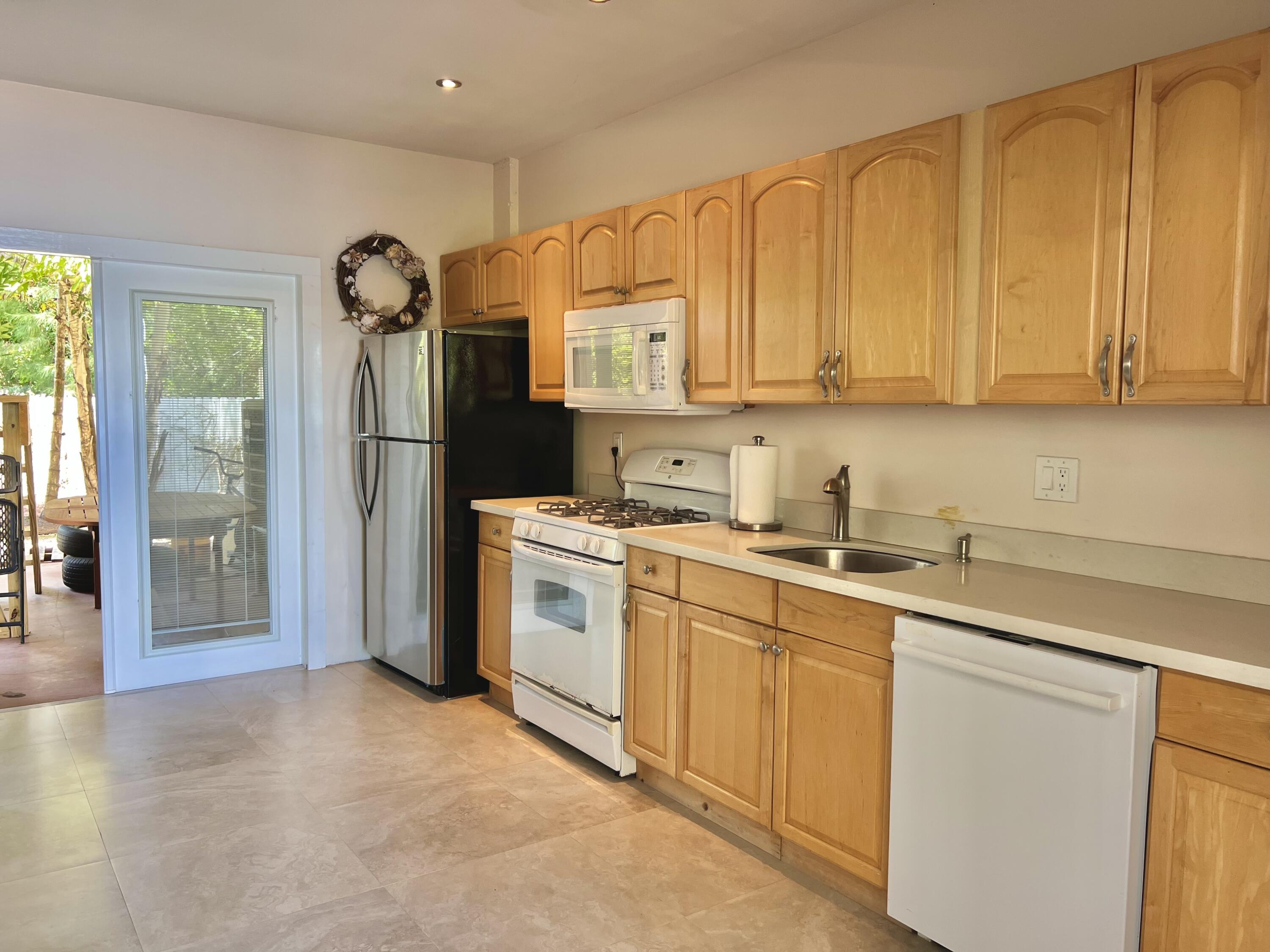 24 Bounty Lane Key Largo, FL 33037 - Photo 18 of 36 a kitchen with a sink cabinets and appliances