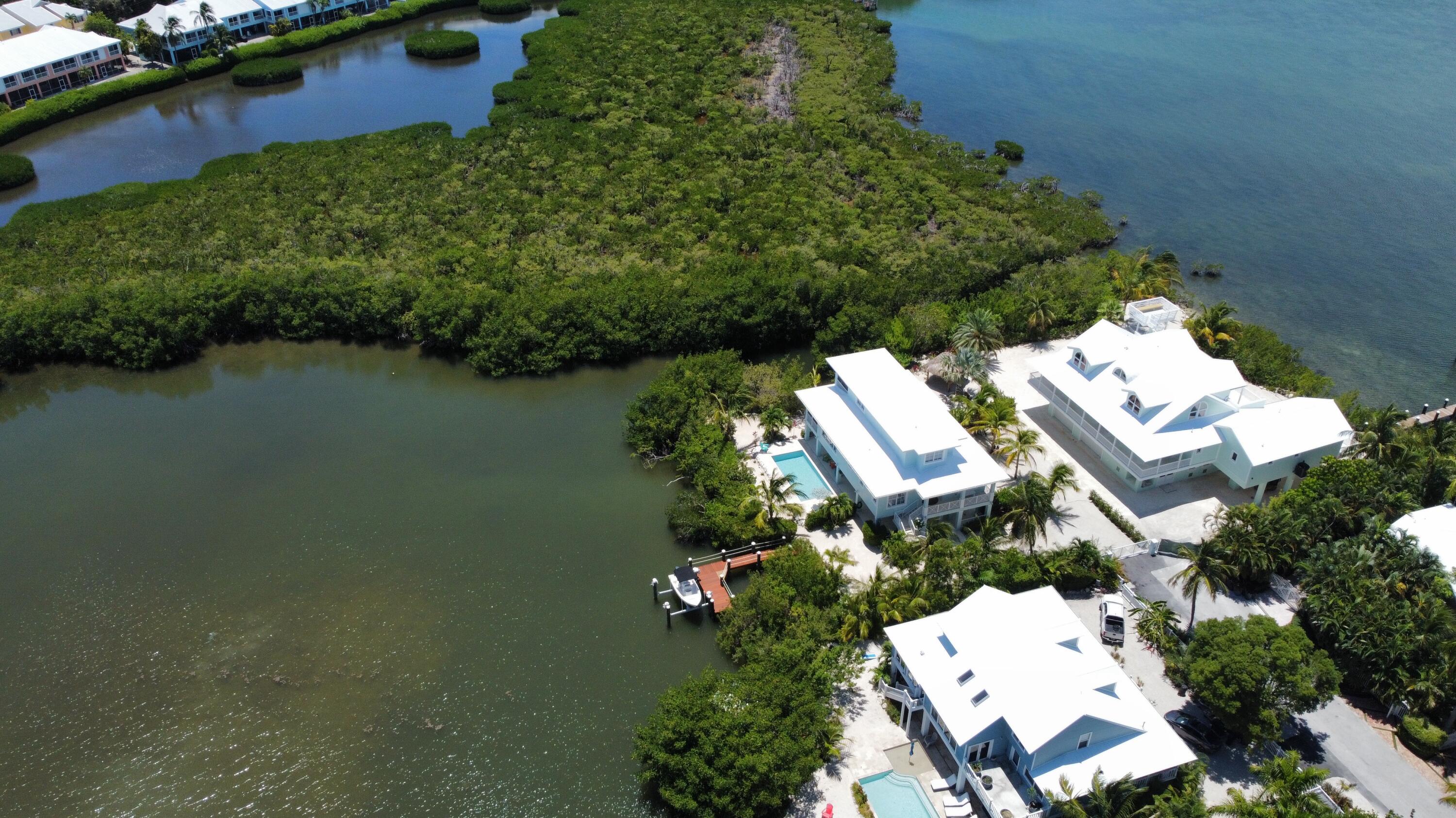 24 Bounty Lane Key Largo, FL 33037 - Photo 25 of 36 an aerial view of a house with a garden and lake view