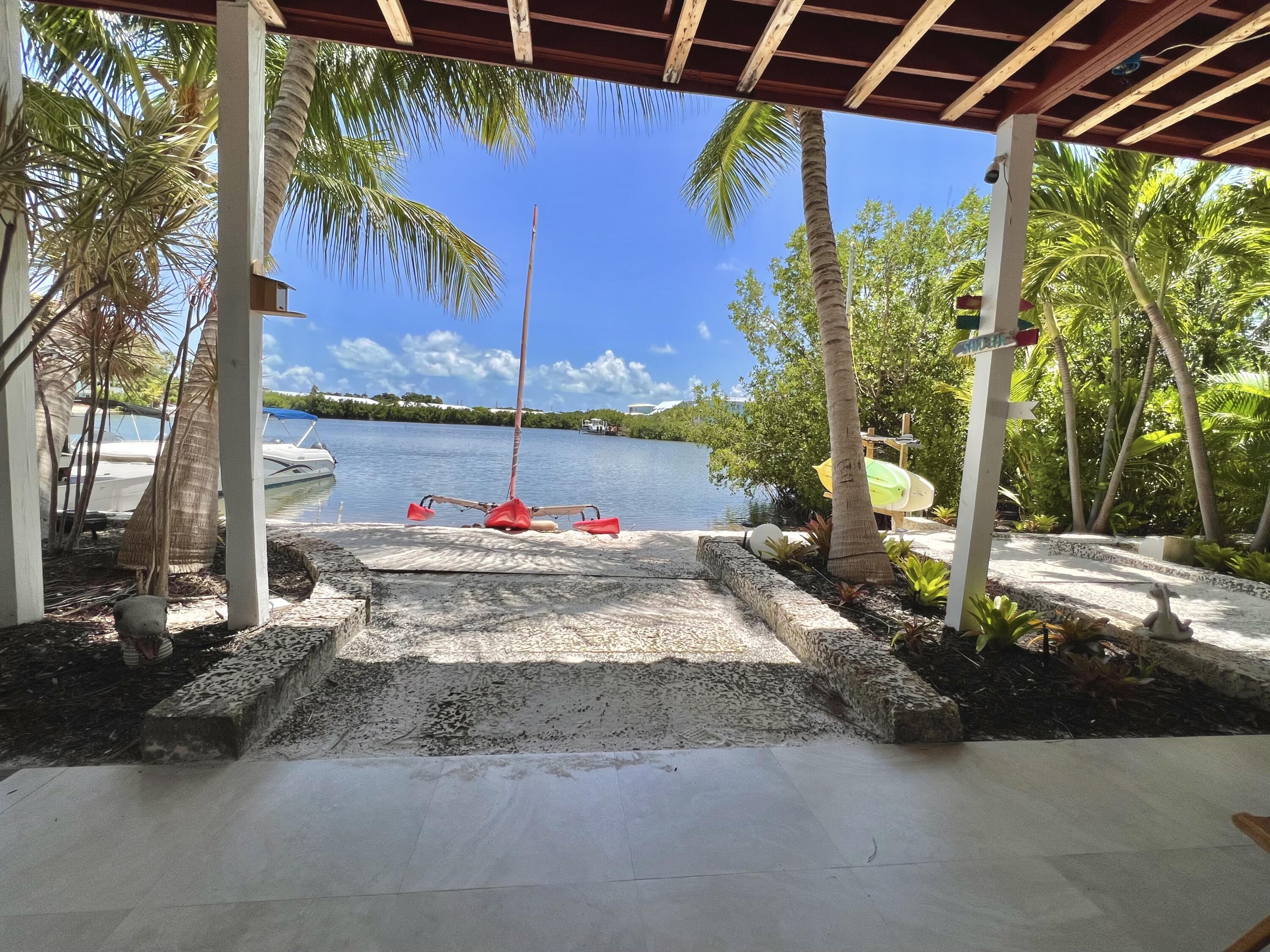 24 Bounty Lane Key Largo, FL 33037 - Photo 31 of 36 a view of yard with swimming pool and sitting area
