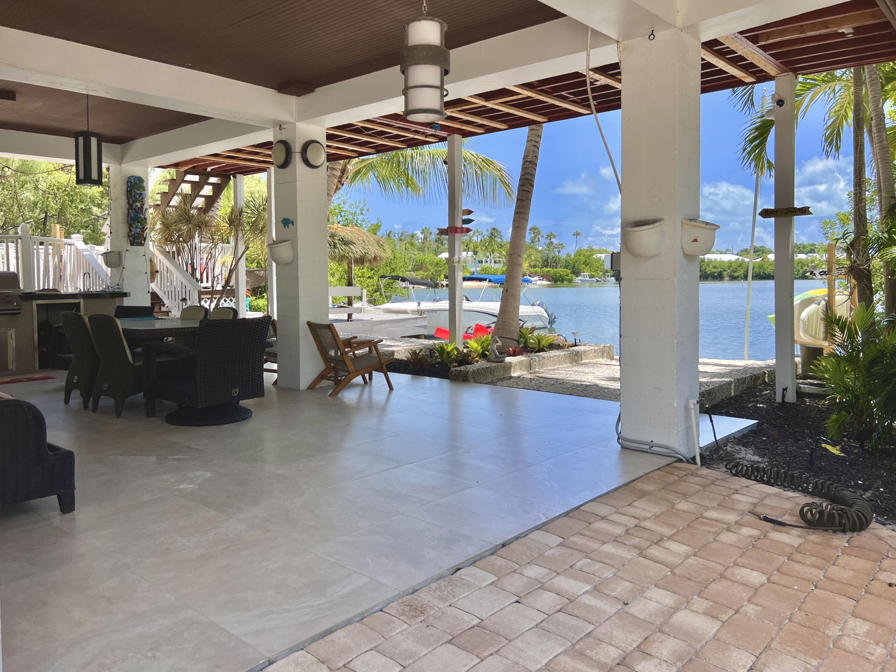24 Bounty Lane Key Largo, FL 33037 - Photo 4 of 36 a living room with patio furniture and a floor to ceiling window