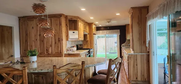 a large kitchen with kitchen island granite countertop a large window