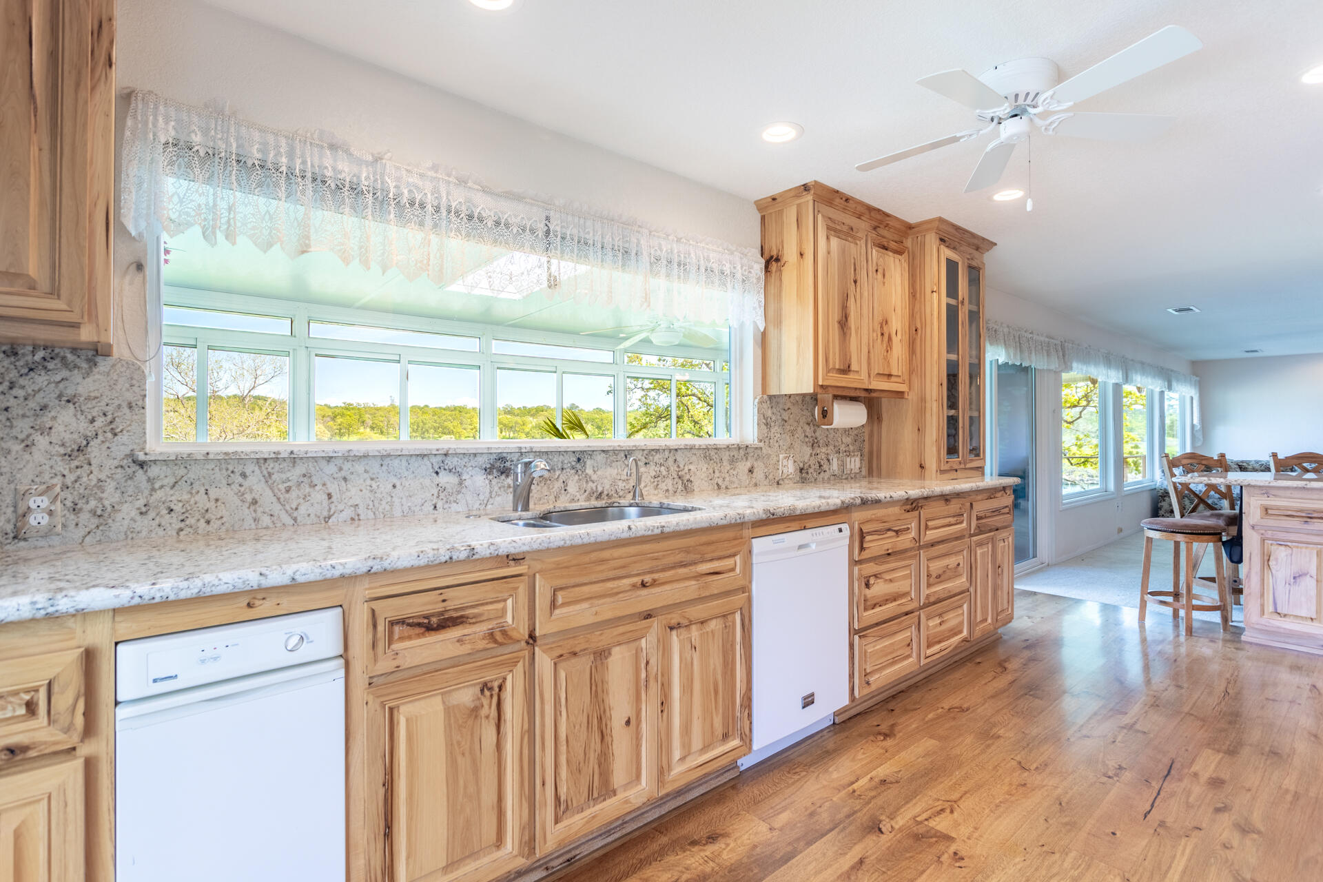 22425 Brent Road Red Bluff, CA 96080 - Photo 14 of 62 a large kitchen with kitchen island granite countertop a large window