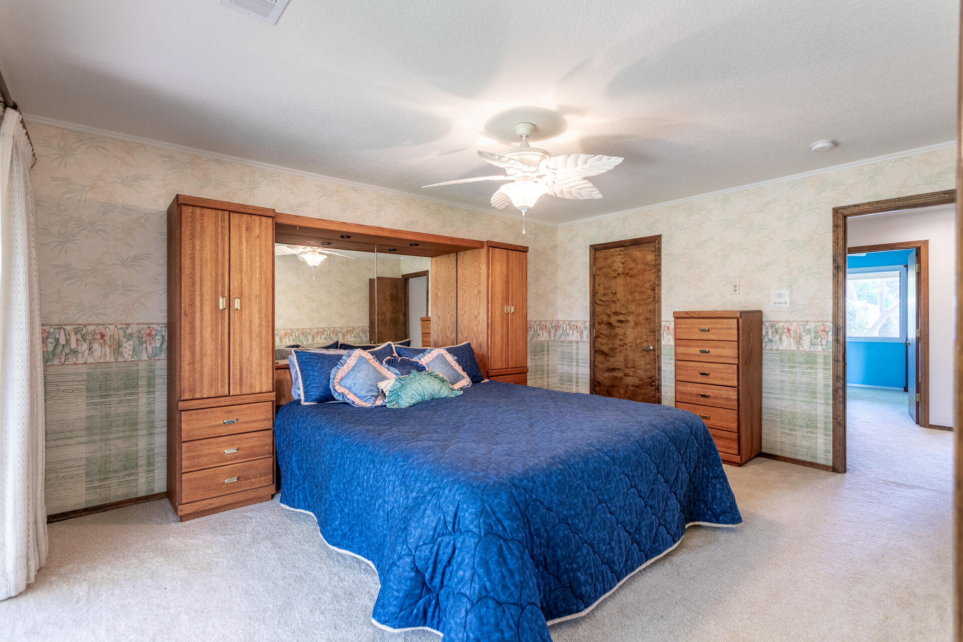 22425 Brent Road Red Bluff, CA 96080 - Photo 25 of 62 a bedroom with a large bed and a chandelier