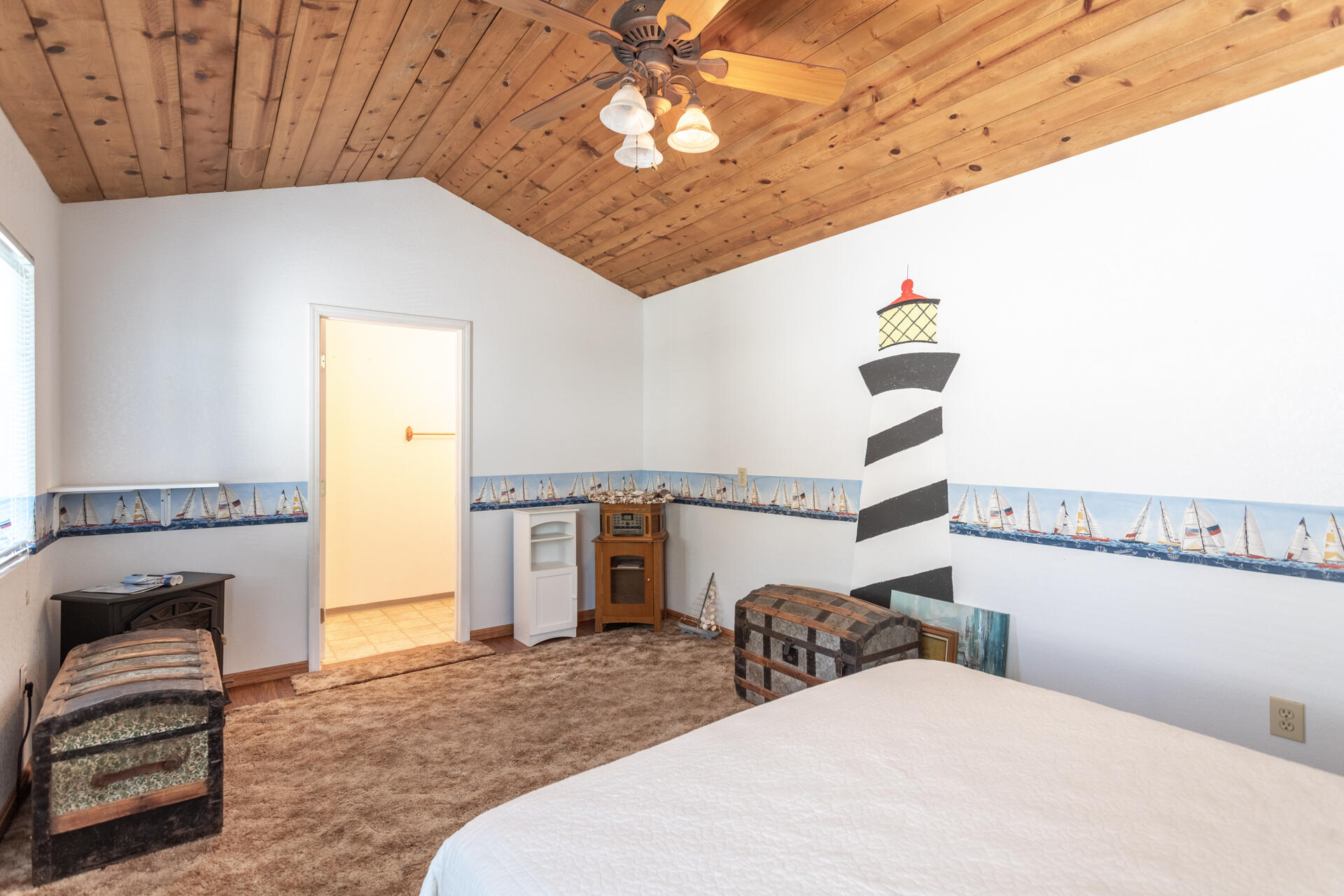 22425 Brent Road Red Bluff, CA 96080 - Photo 34 of 62 a bedroom with a bed and a chandelier