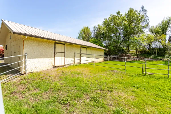 a view of a house with backyard and deck