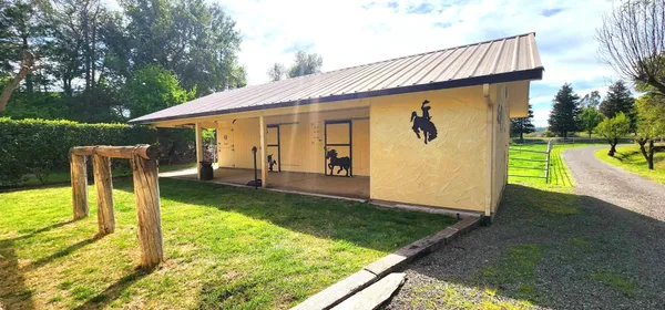 a view of a house with a tree in the background