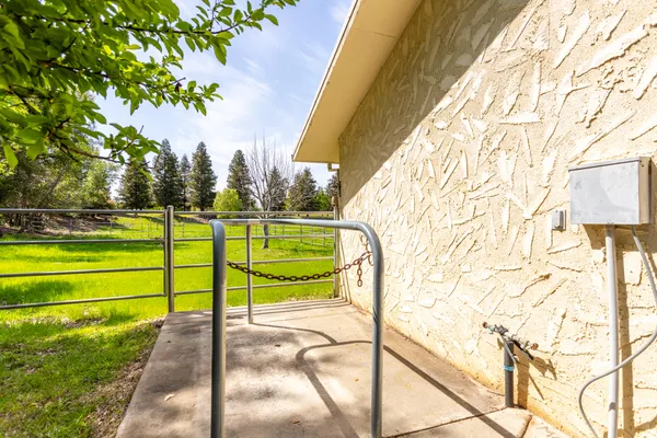 a view of a yard with wooden fence
