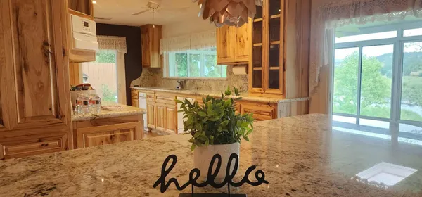a kitchen with a stove a sink and a wooden cabinets