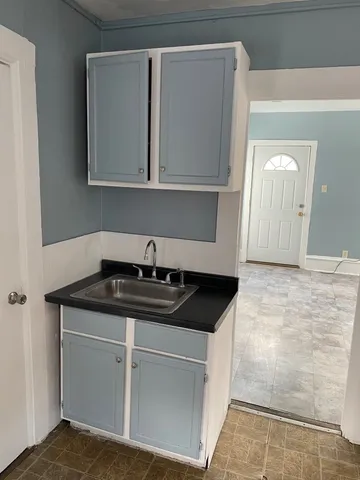 a kitchen with white cabinets and a sink