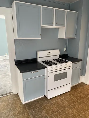 a kitchen with white cabinets and white appliances