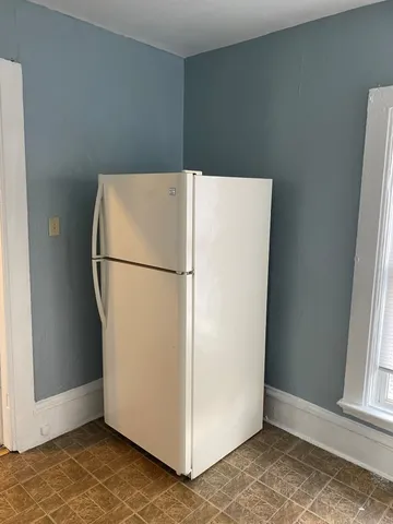 a white refrigerator freezer sitting in a kitchen