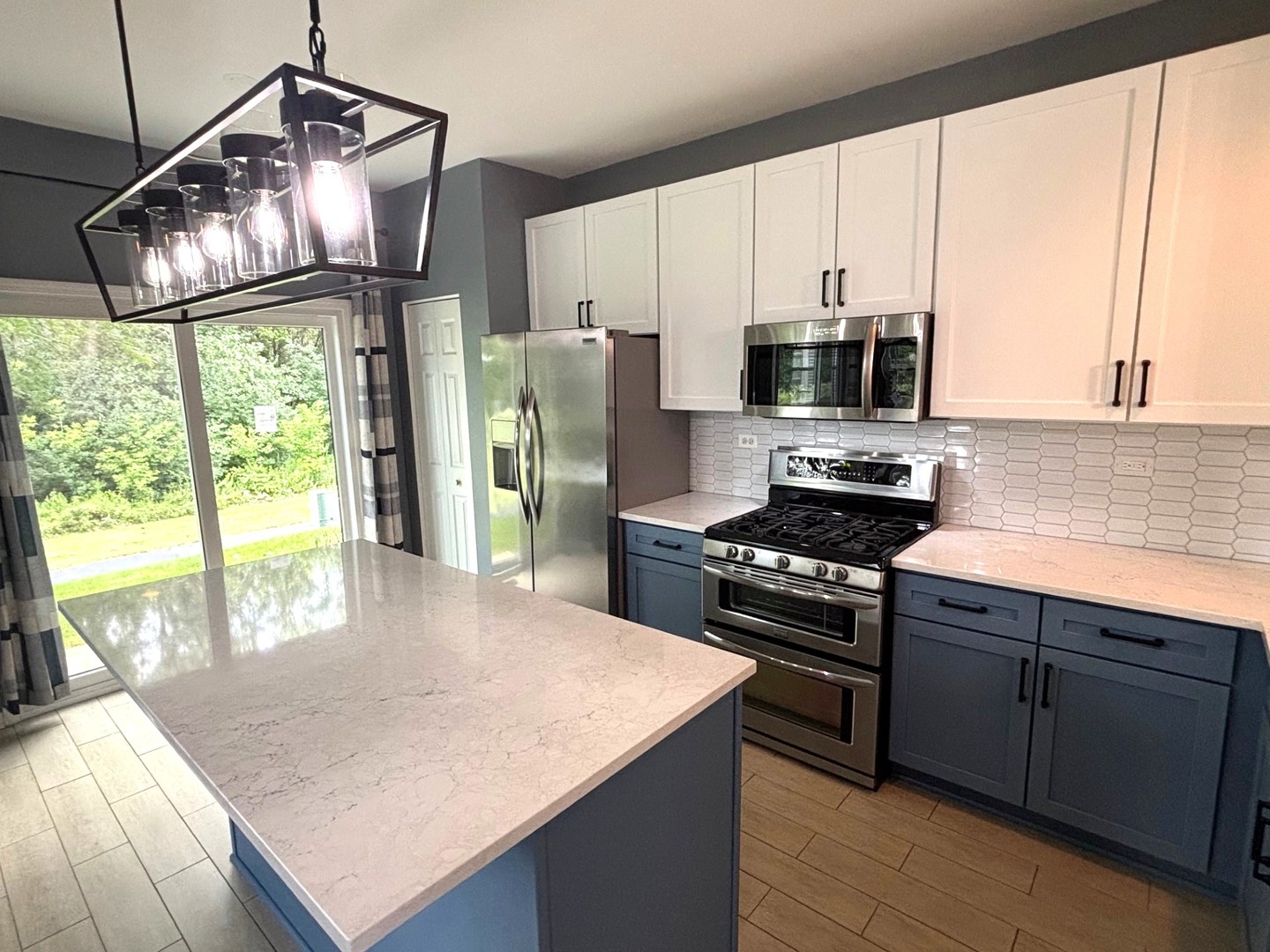 2468 Reflections Drive Aurora, IL 60502 - Photo 15 of 44 a kitchen with stainless steel appliances granite countertop a stove a sink and a refrigerator