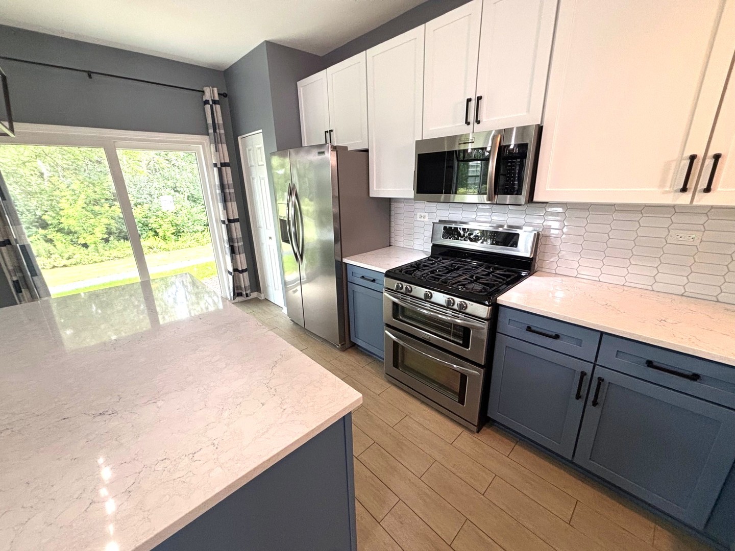 2468 Reflections Drive Aurora, IL 60502 - Photo 16 of 44 a kitchen with stainless steel appliances a stove a sink and a microwave