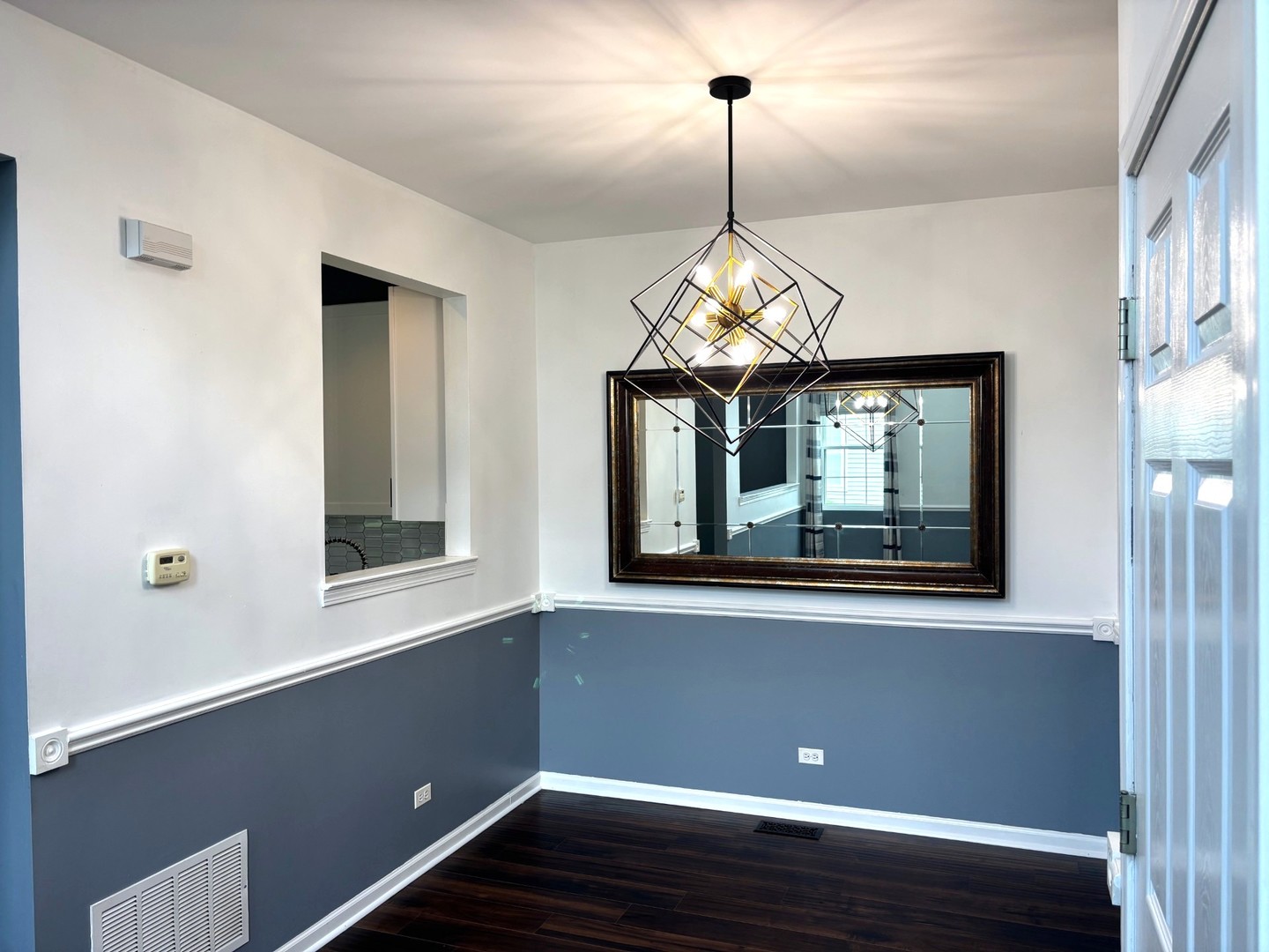 2468 Reflections Drive Aurora, IL 60502 - Photo 18 of 44 a view of wooden floor and chandelier in a room