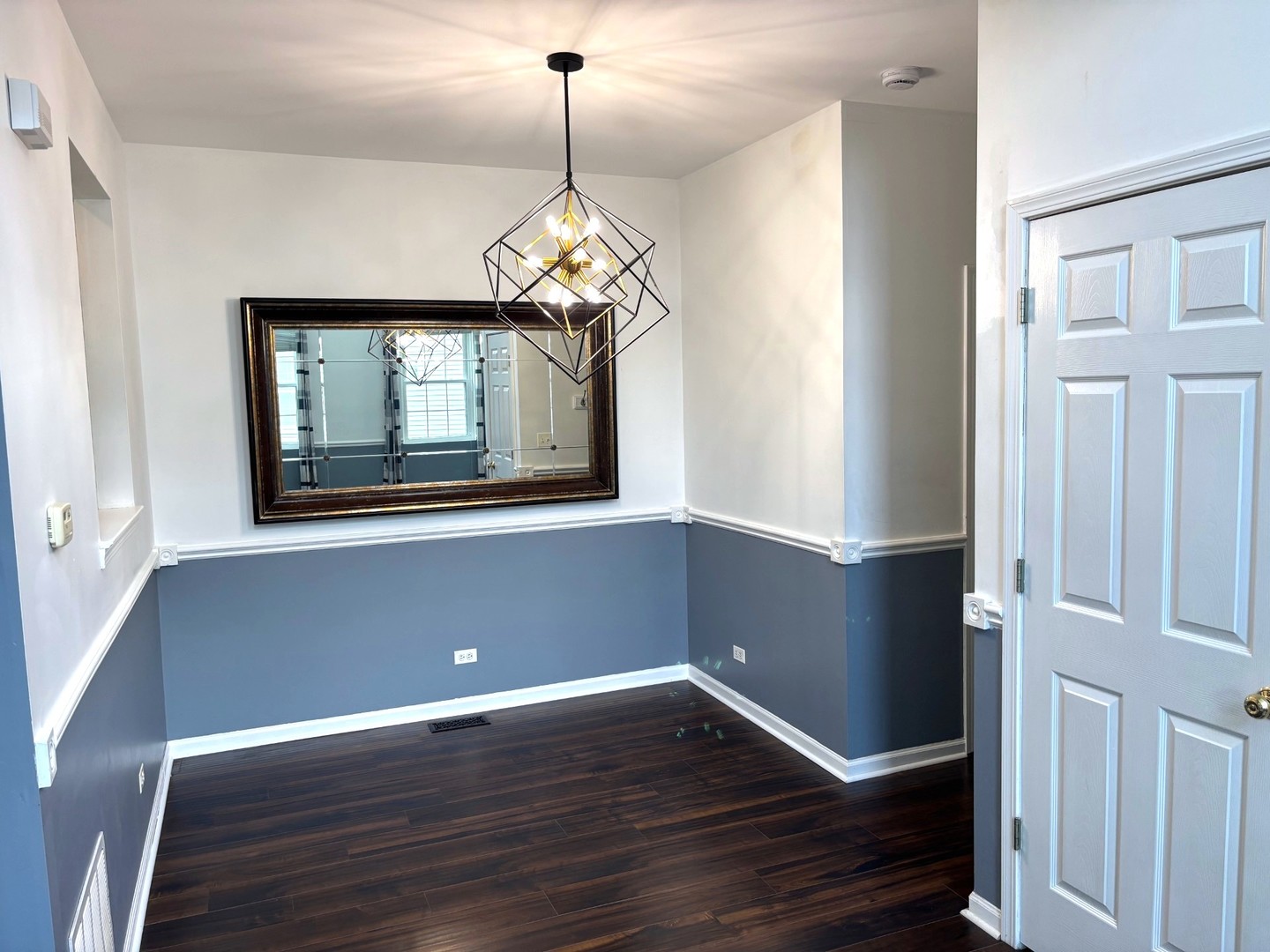 2468 Reflections Drive Aurora, IL 60502 - Photo 19 of 44 a view of a room with wooden floor chandelier and windows