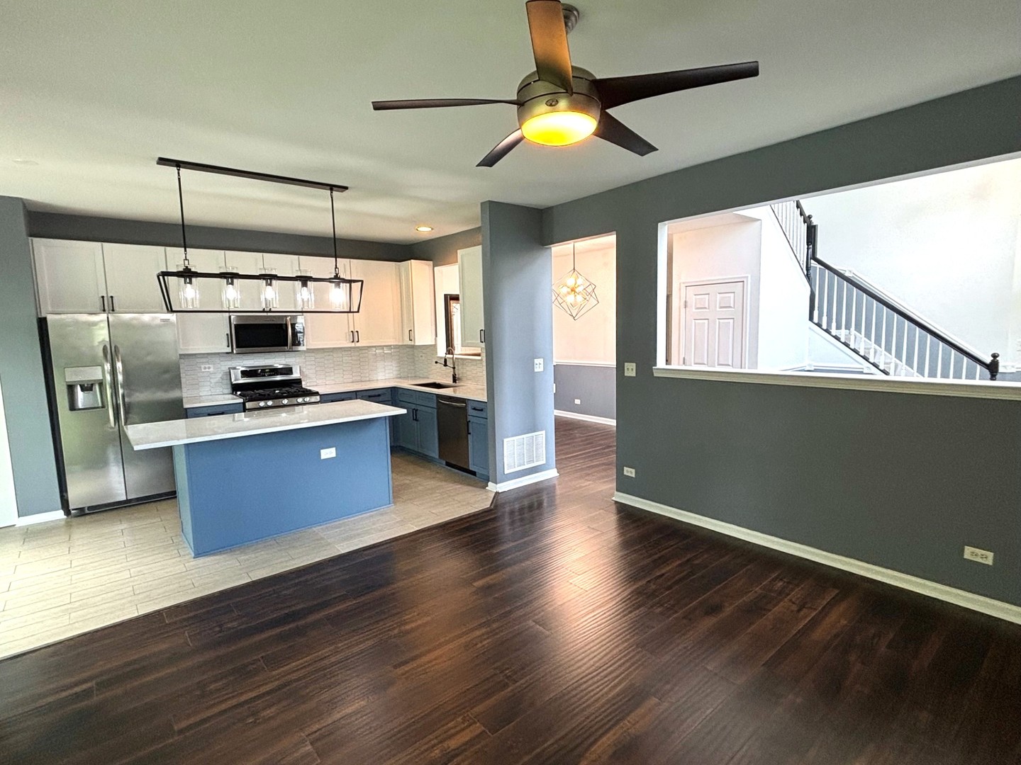2468 Reflections Drive Aurora, IL 60502 - Photo 6 of 44 a kitchen with stainless steel appliances kitchen island granite countertop a stove a sink and a refrigerator