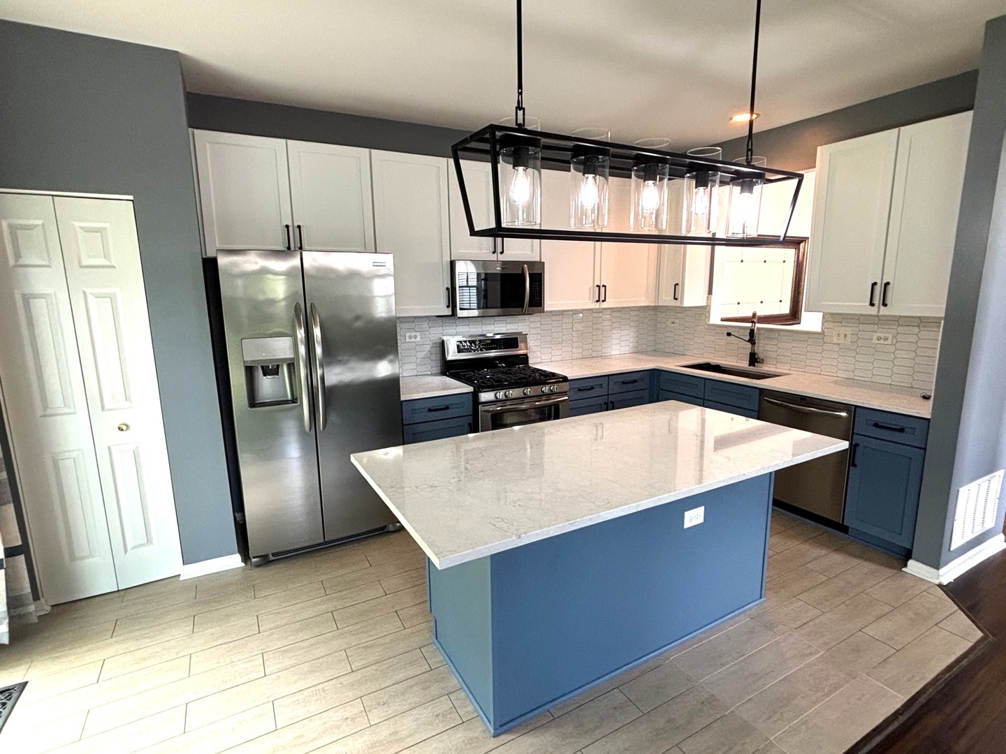 2468 Reflections Drive Aurora, IL 60502 - Photo 10 of 44 a kitchen with stainless steel appliances granite countertop a sink a refrigerator a washer and dryer