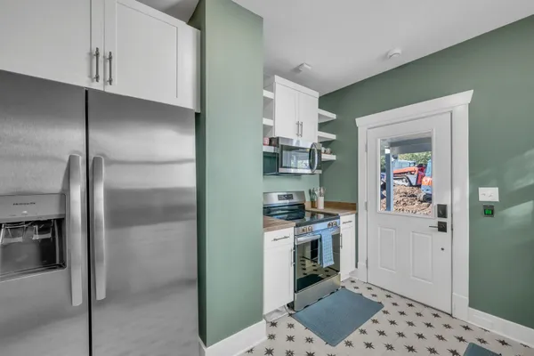 a kitchen with stainless steel appliances a refrigerator and a stove