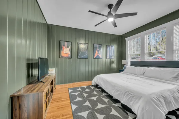 a bedroom with a bed and a chandelier