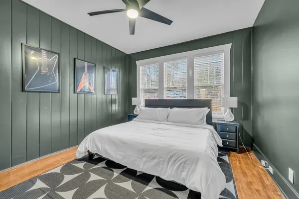 a bedroom with a bed and a chandelier