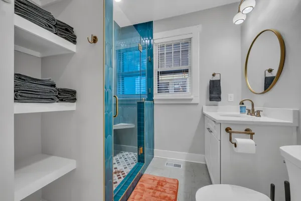 a bathroom with a sink toilet and shower