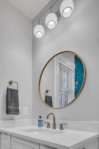 a bathroom with a sink and mirror
