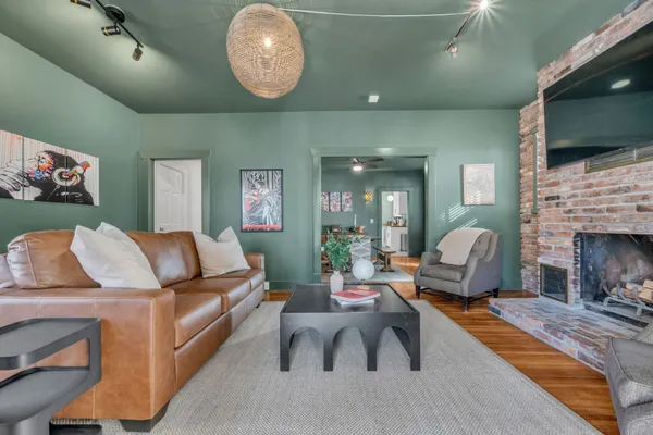 a living room with furniture a flat screen tv and a fireplace