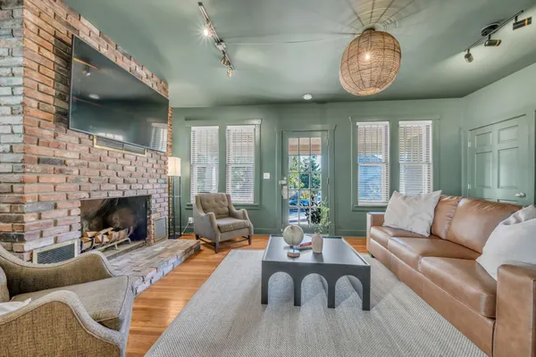 a living room with furniture chandelier and a fireplace