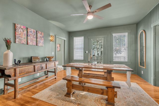 a living room with furniture a table and wooden floor