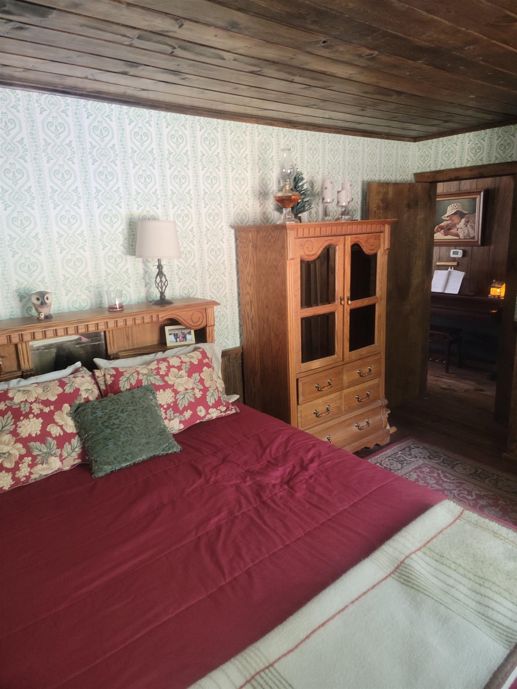 11702 Twin Lakes Road Bridgeport, CA 93517 - Photo 19 of 21 Bedroom featuring a wood-panel ceiling, patterned wallpaper, and wood-finish flooring