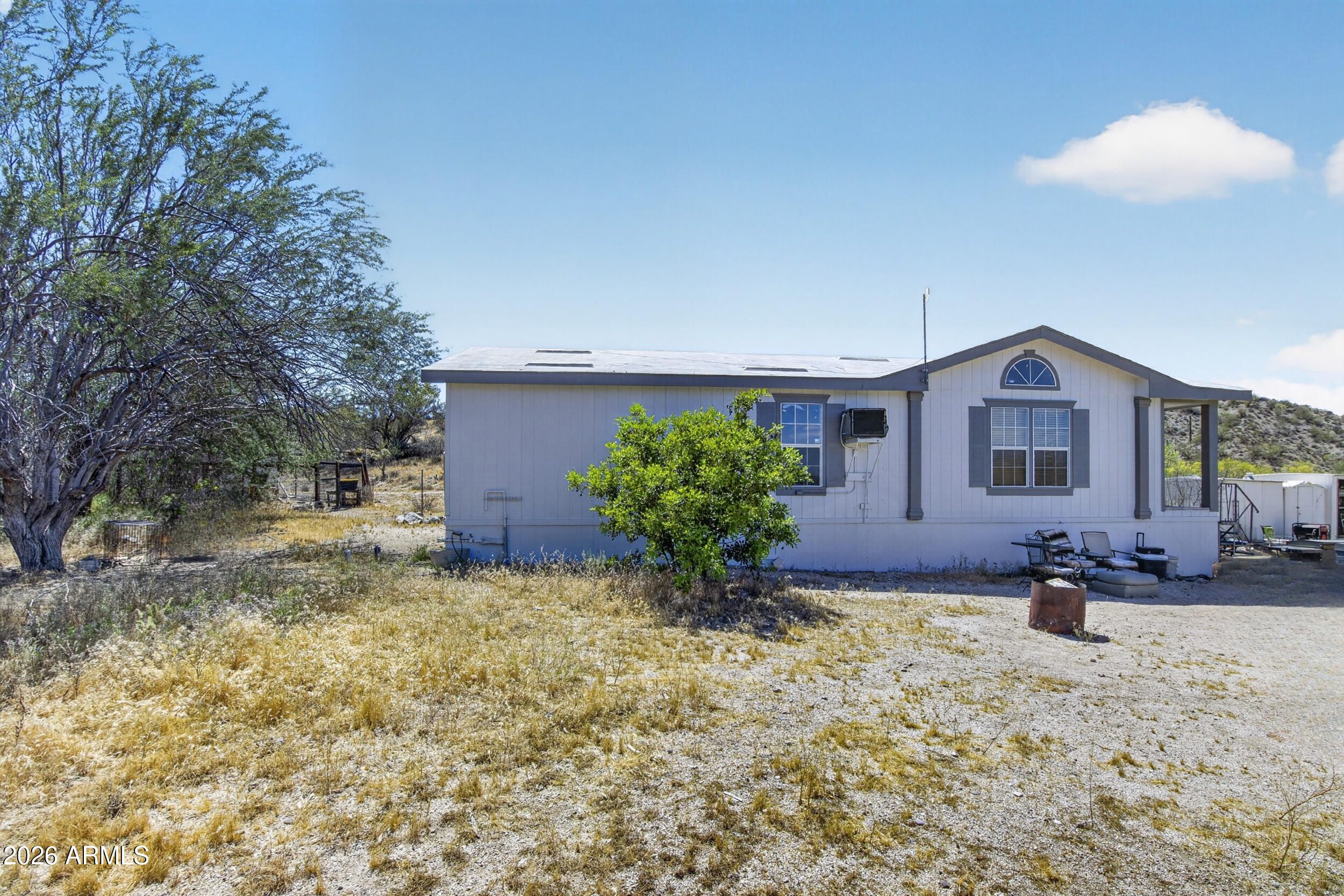 a front view of a house with a yard and a garden