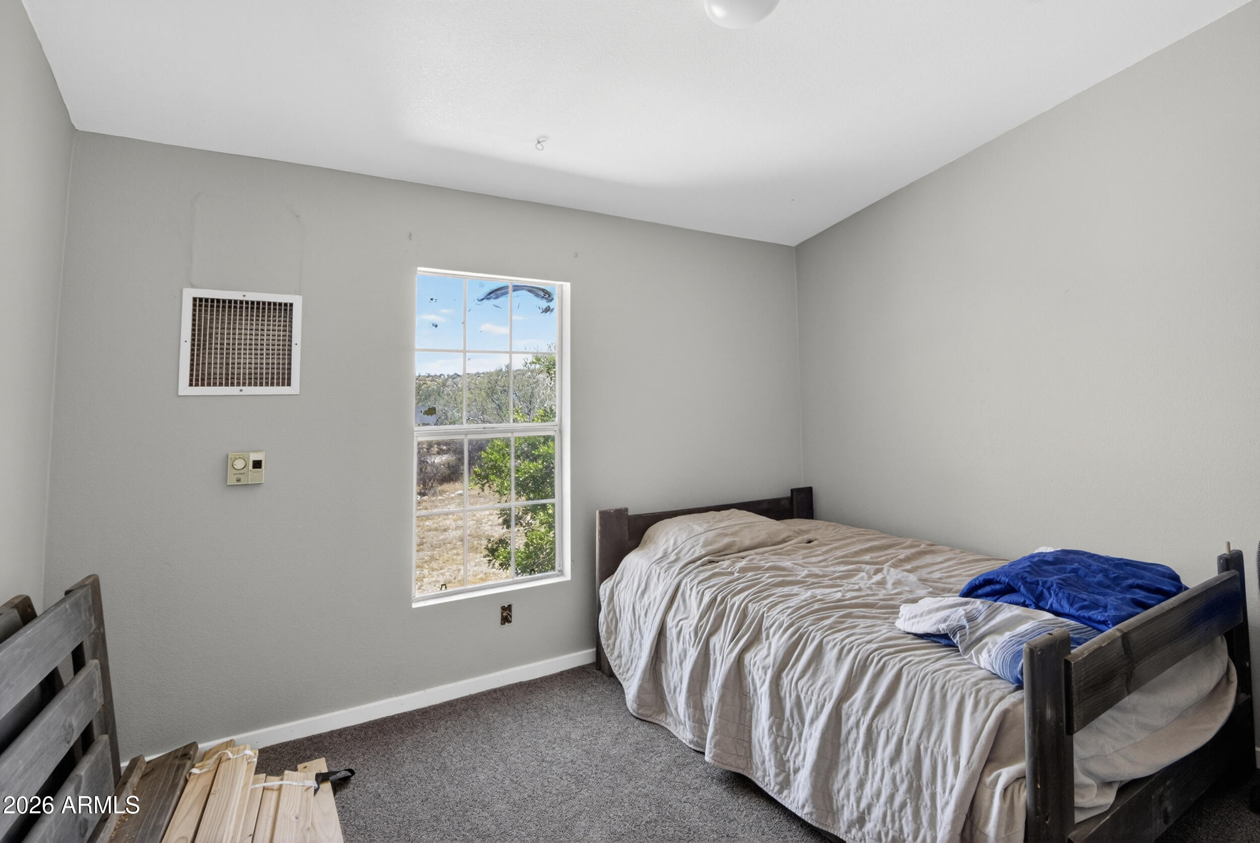 38809 East Spotted Horse Road Florence, AZ 85132 - Photo 19 of 40 a bed sitting in a bedroom next to a window