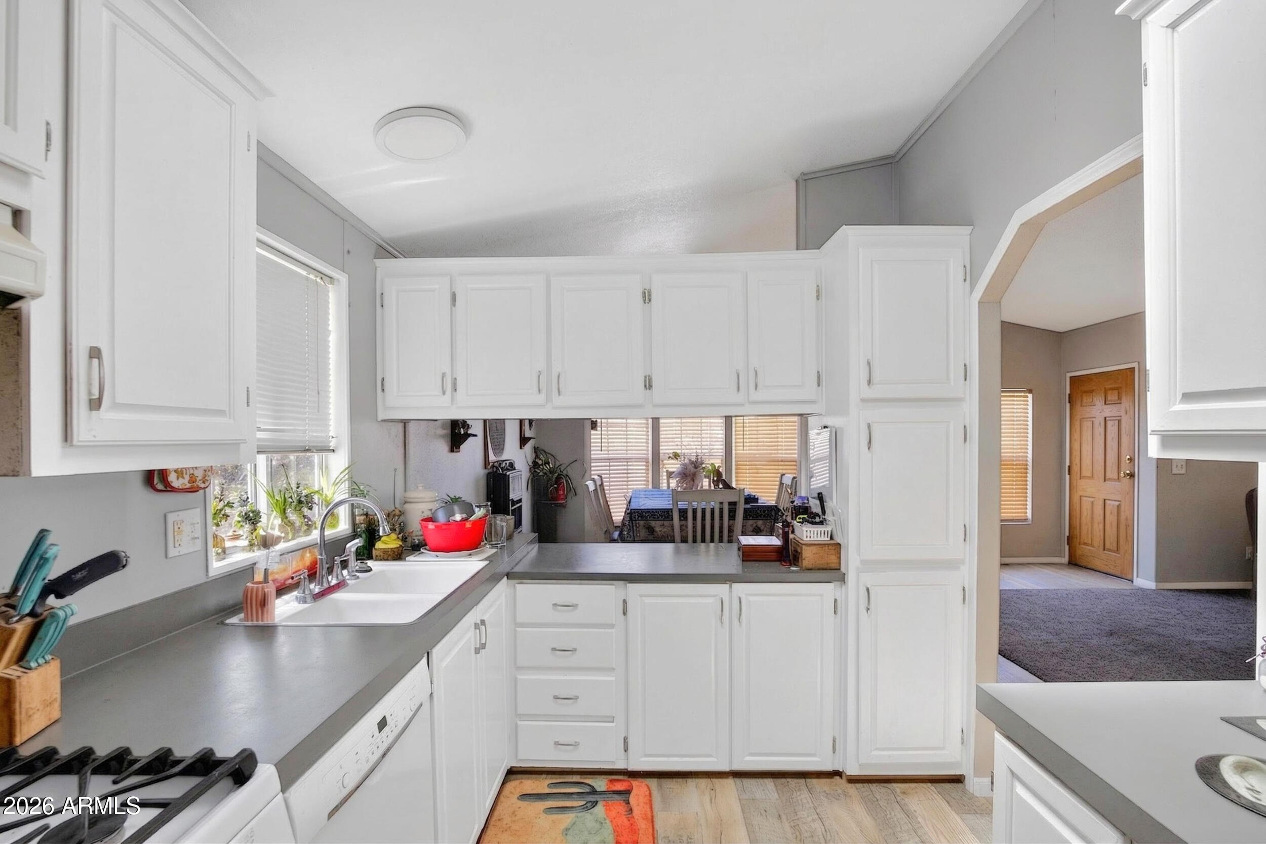 38809 East Spotted Horse Road Florence, AZ 85132 - Photo 6 of 40 a kitchen with white cabinets and sink