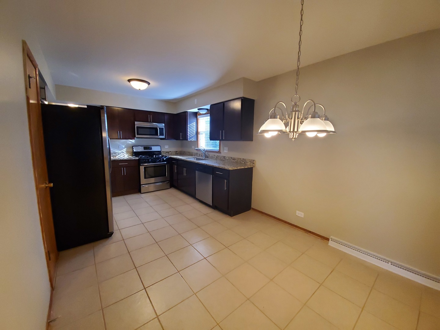 8307 Ballard Road Niles, IL 60714 - Photo 11 of 22 a kitchen with stainless steel appliances granite countertop a refrigerator and a stove top oven