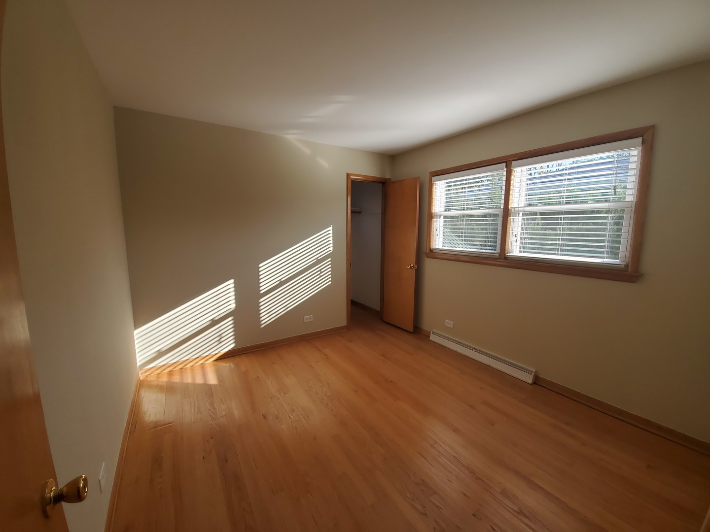 8307 Ballard Road Niles, IL 60714 - Photo 5 of 22 an empty room with wooden floor and windows