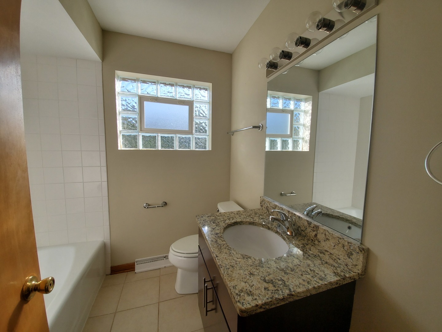 8307 Ballard Road Niles, IL 60714 - Photo 7 of 22 a bathroom with a granite countertop sink and a mirror