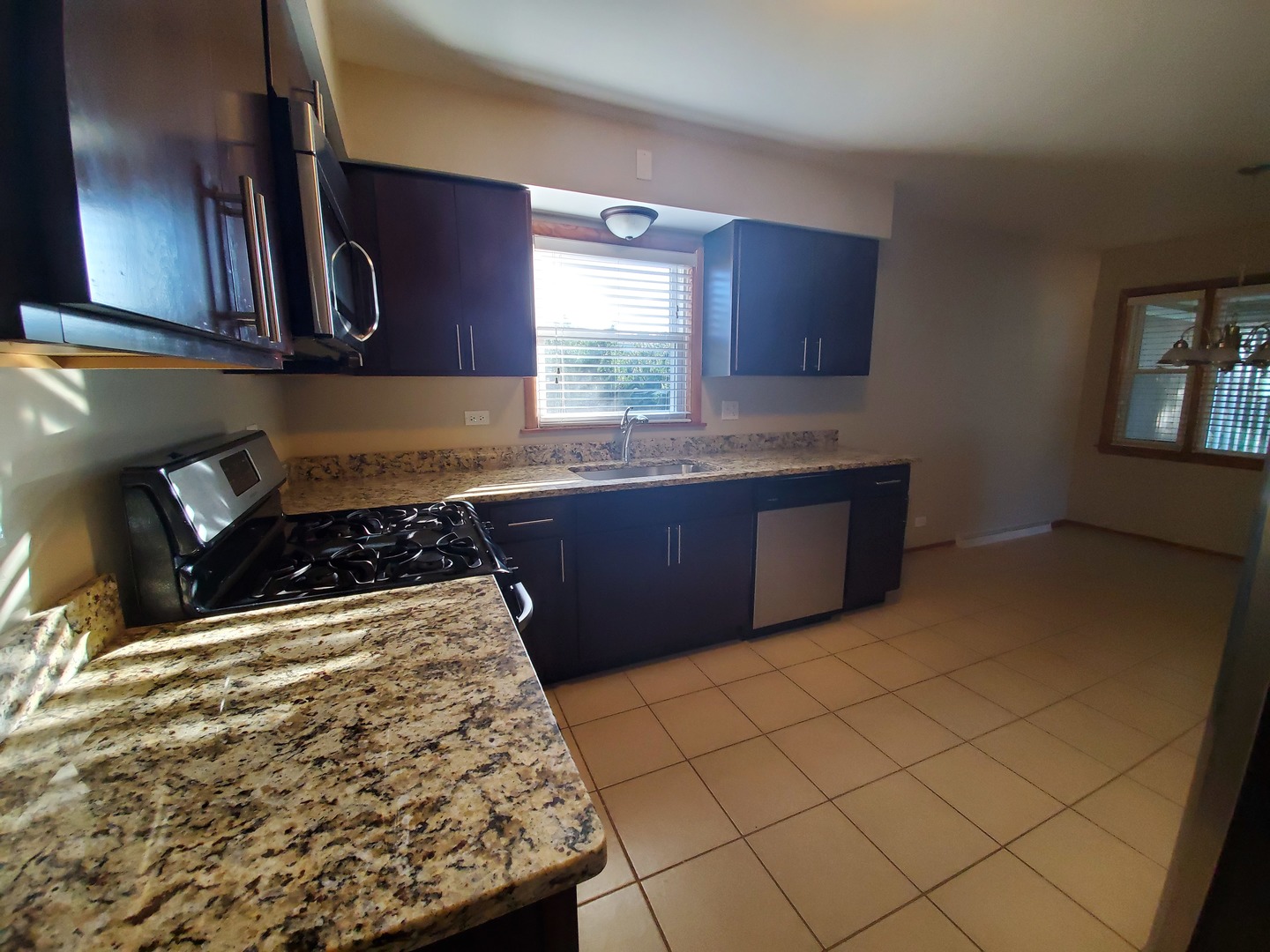 8307 Ballard Road Niles, IL 60714 - Photo 10 of 22 a kitchen with wooden cabinets and a stove