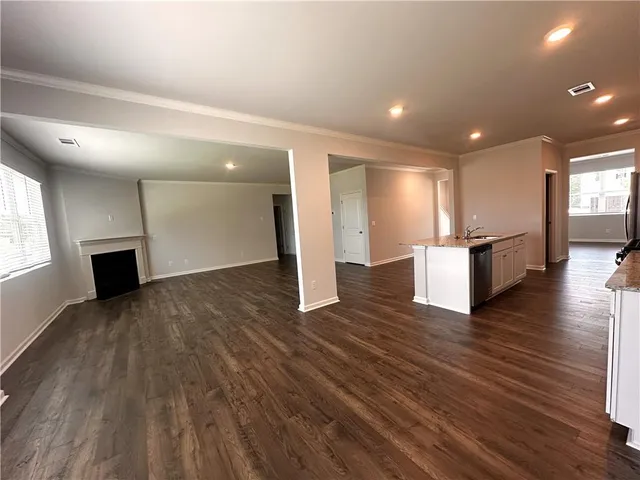 a view of kitchen with refrigerator microwave and wooden floor