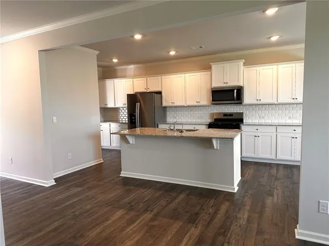 a kitchen with stainless steel appliances a refrigerator sink and microwave
