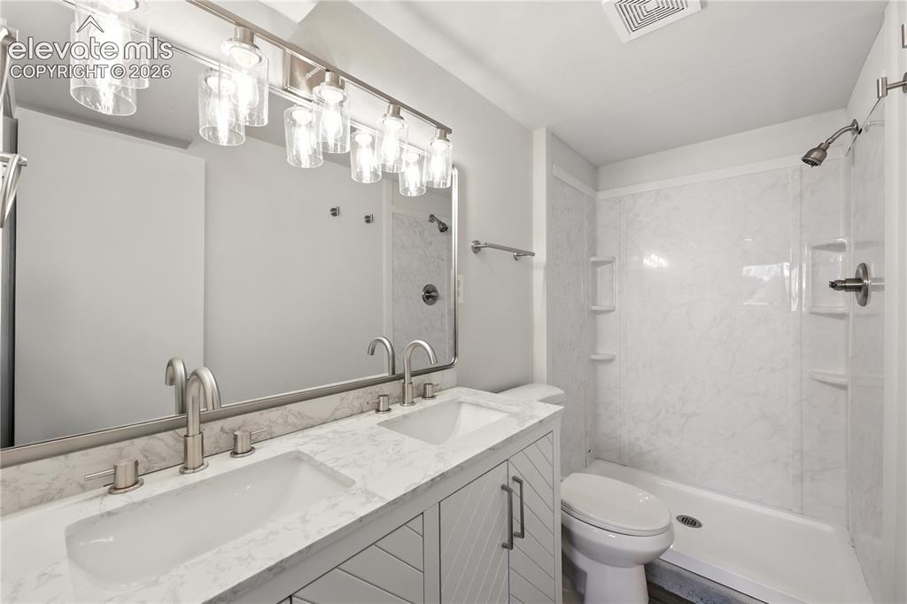 7033 Sequoyah Way Colorado Springs, CO 80915 - Photo 18 of 20 a bathroom with a sink a toilet and shower