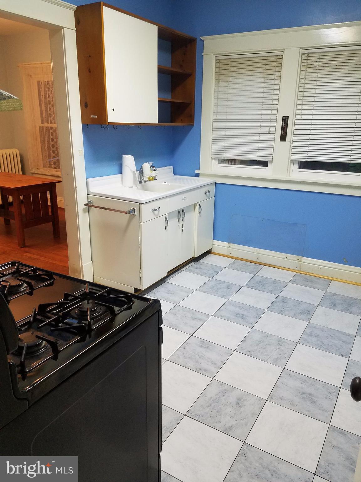 4429 P Street Northwest Washington, DC 20007 - Photo 7 of 11 a kitchen with a sink stove and cabinets