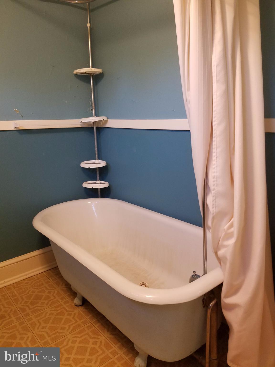 4429 P Street Northwest Washington, DC 20007 - Photo 9 of 11 a white bath tub sitting in a bathroom