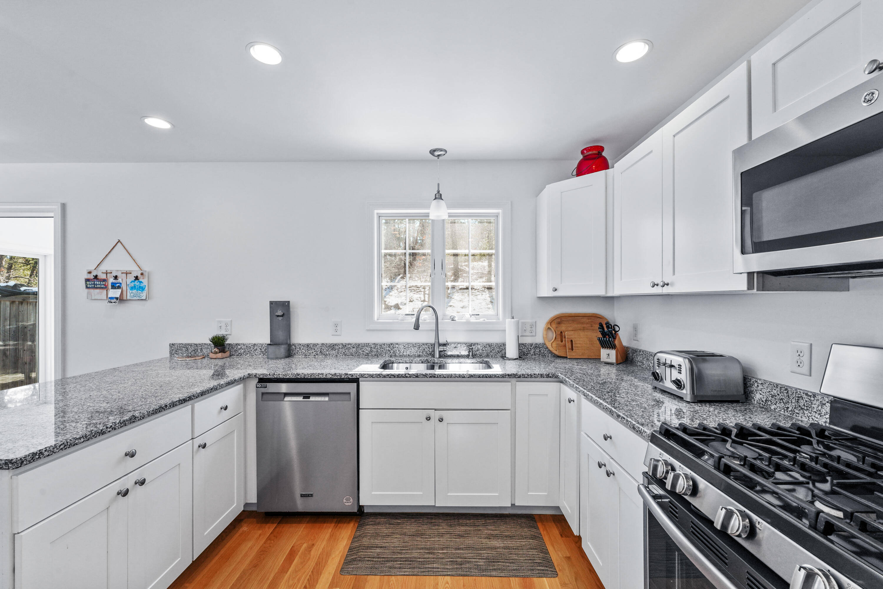 45 Perch Pond Way Wellfleet, MA 02667 - Photo 17 of 82 a kitchen with granite countertop a sink stove and cabinets