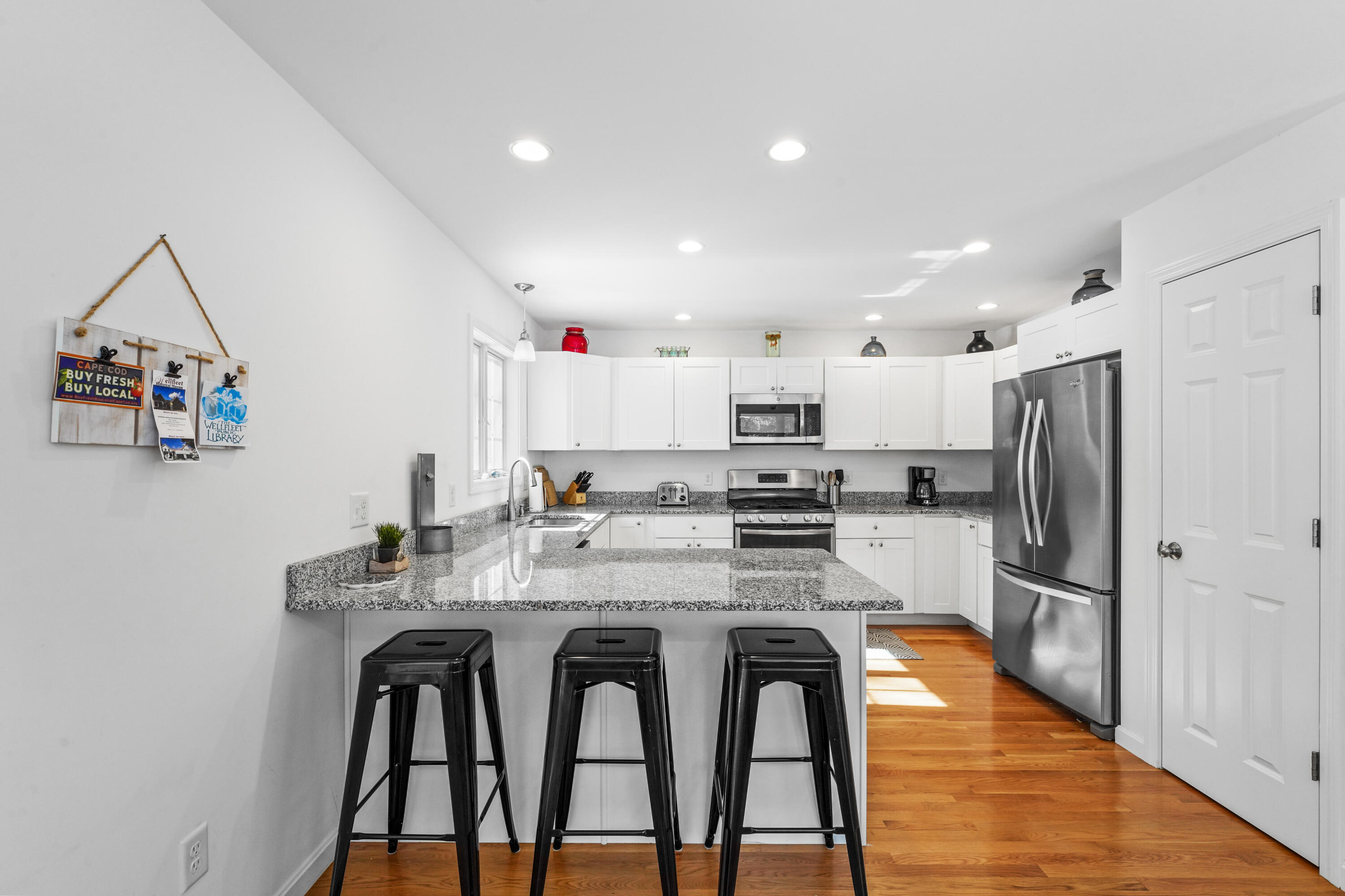 45 Perch Pond Way Wellfleet, MA 02667 - Photo 19 of 82 a kitchen with stainless steel appliances kitchen island granite countertop a refrigerator and a stove top oven