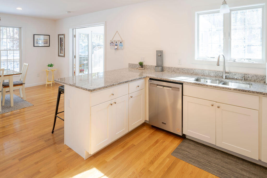 45 Perch Pond Way Wellfleet, MA 02667 - Photo 24 of 82 a kitchen with granite countertop white cabinets and white appliances