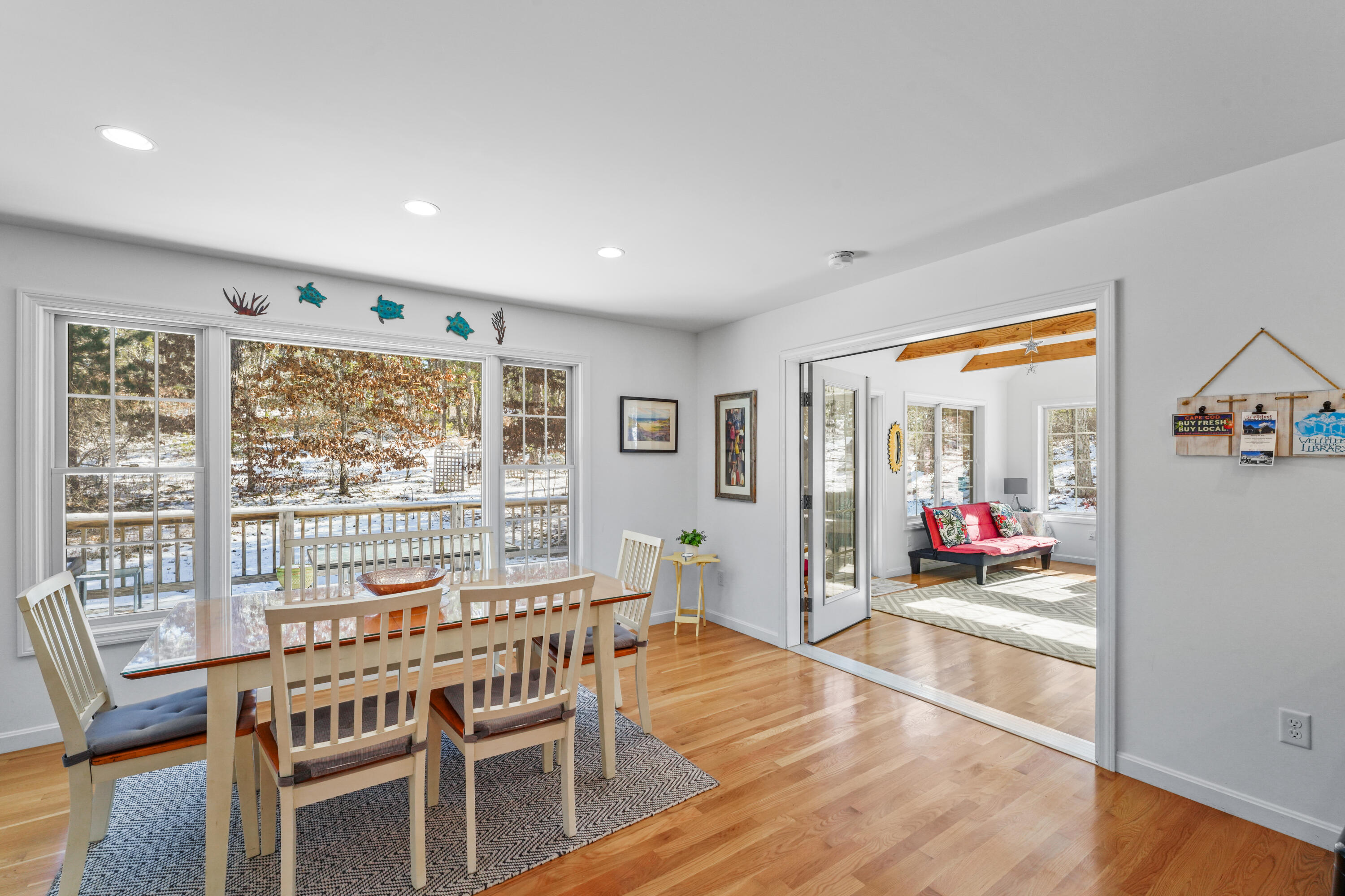 45 Perch Pond Way Wellfleet, MA 02667 - Photo 28 of 82 a dining room with wooden floor and glass door