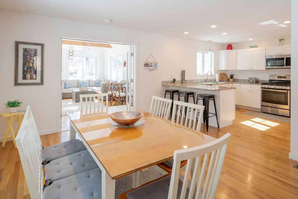 45 Perch Pond Way Wellfleet, MA 02667 - Photo 29 of 82 a kitchen with stainless steel appliances granite countertop a kitchen island a stove a table and chairs