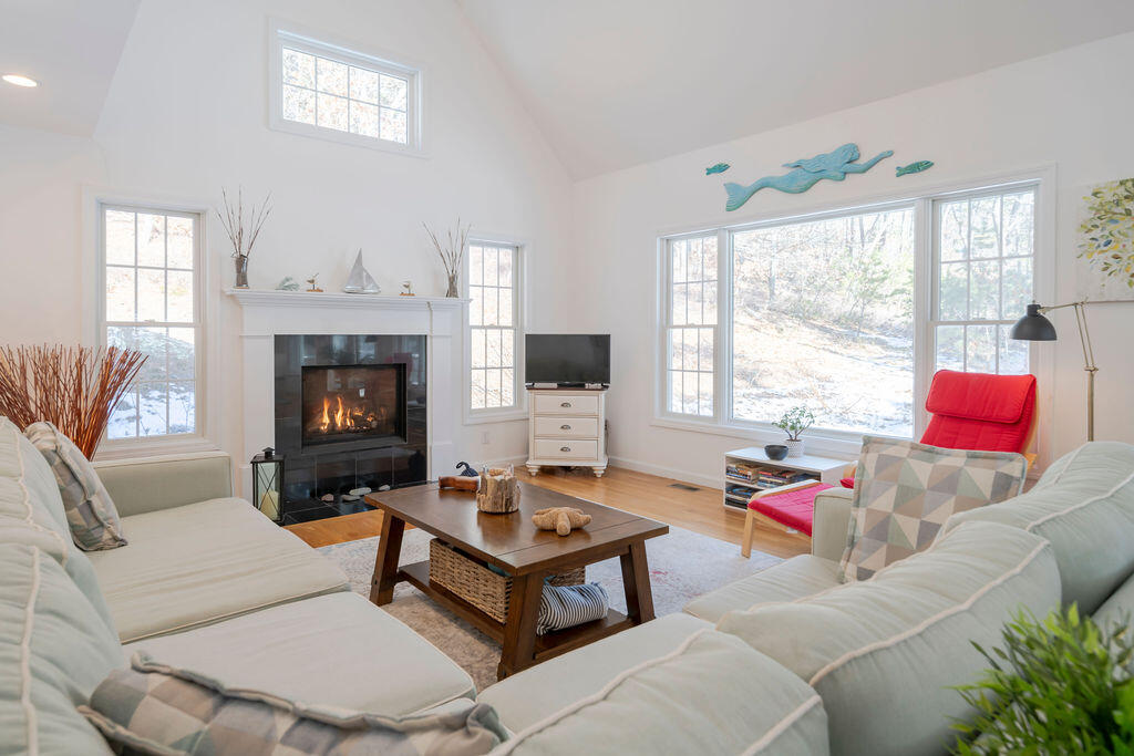 45 Perch Pond Way Wellfleet, MA 02667 - Photo 3 of 82 a living room with furniture a flat screen tv and a fireplace